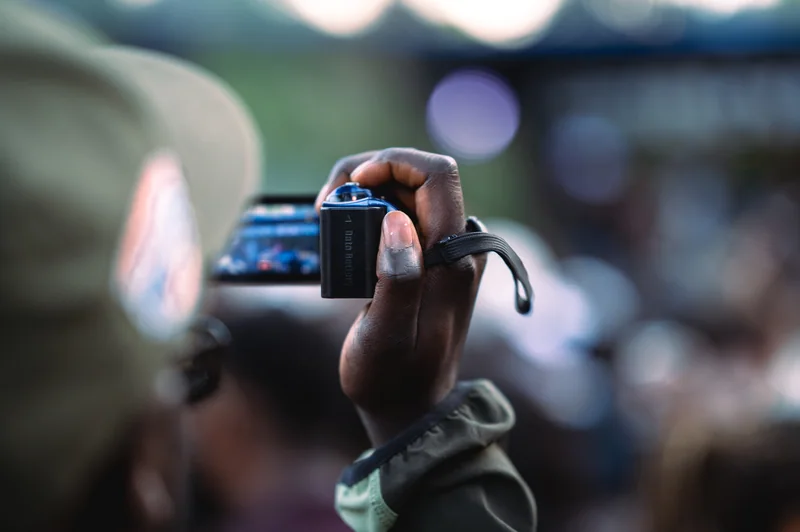 A guest records the festival on a small video camera