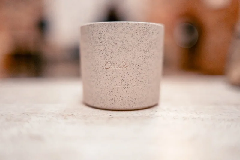 A single speckled ceramic vessel isolated through texture and shallow focus.