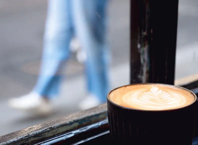 Coffee at the window with a passing figure