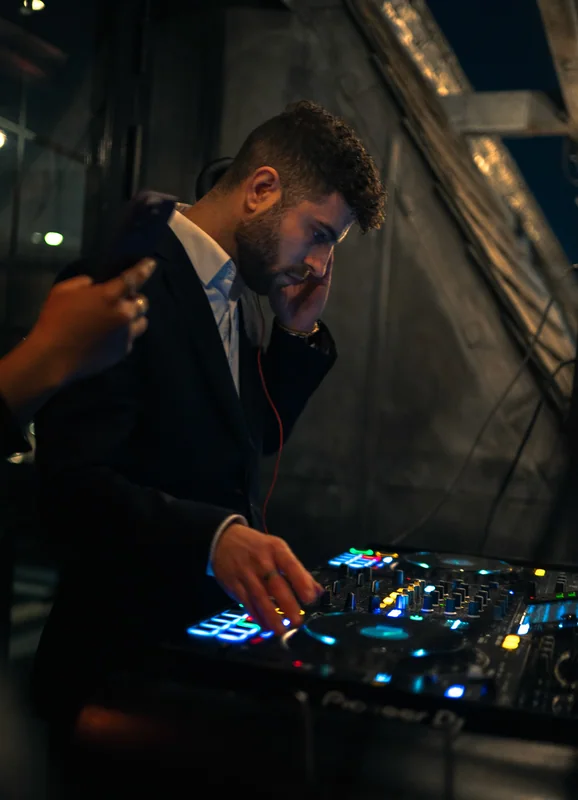 DJ adjusting the mixer at Aqua Nueva