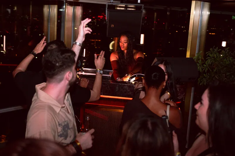DJ at the booth with hands raised in the crowd at CE LA VI