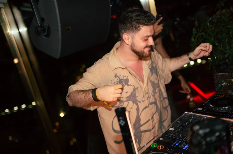 DJ smiling as he performs at CE LA VI