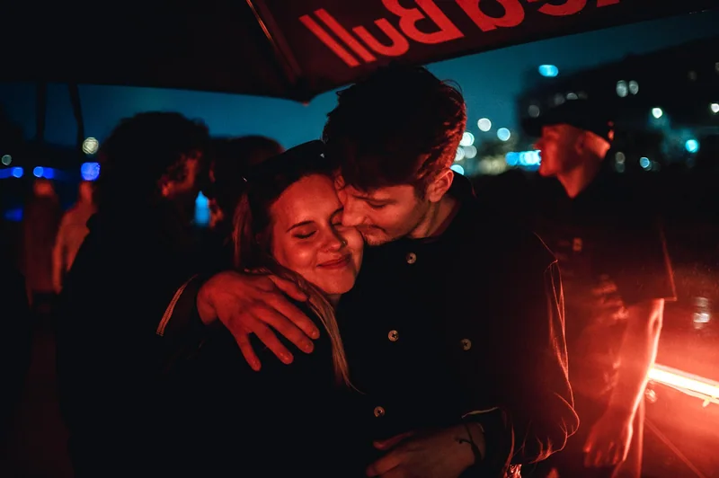 Embrace at the rail with red rim light