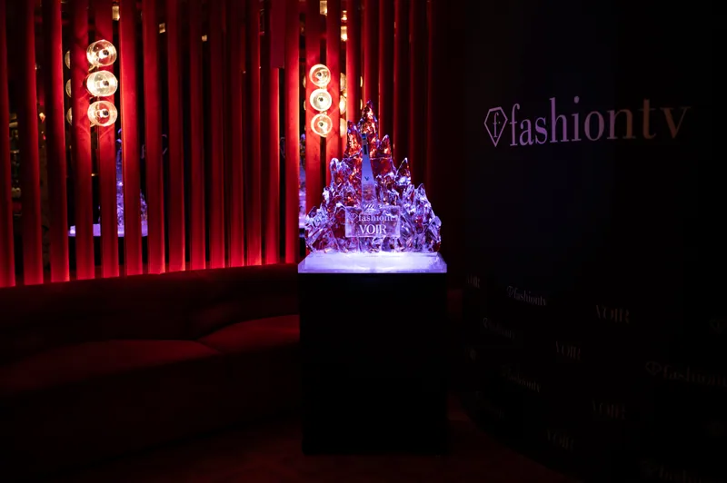 Illuminated ice sculpture against the red FashionTV venue design