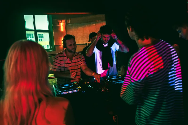 DJs performing under coloured light at Gallery 1986 in Vilnius
