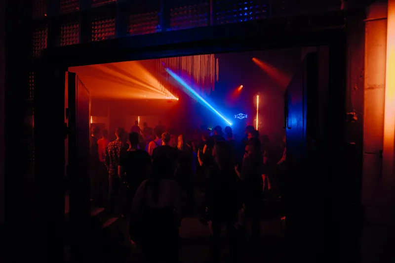 View through the Gallery 1986 doorway to the crowd and coloured lights in Vilnius