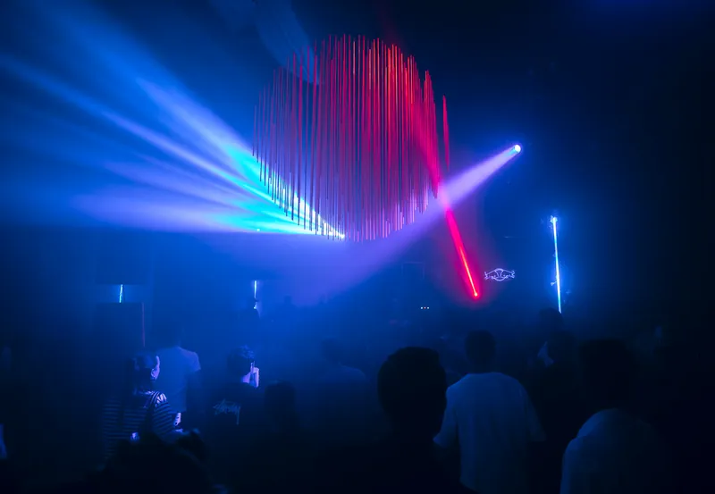 Pink and blue suspended lights above the Gallery 1986 crowd in Vilnius