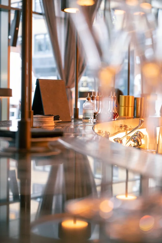 Glassware reflecting light along the hotel bar