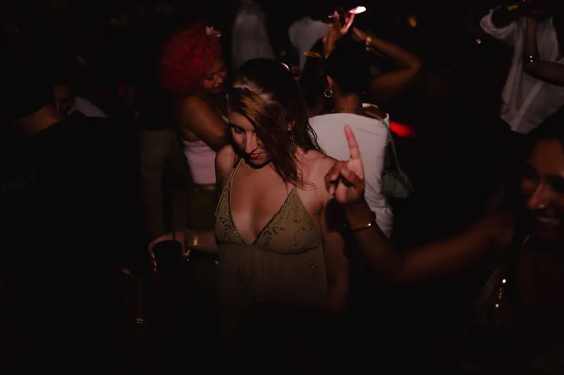 Guest dancing in a gold dress at CE LA VI