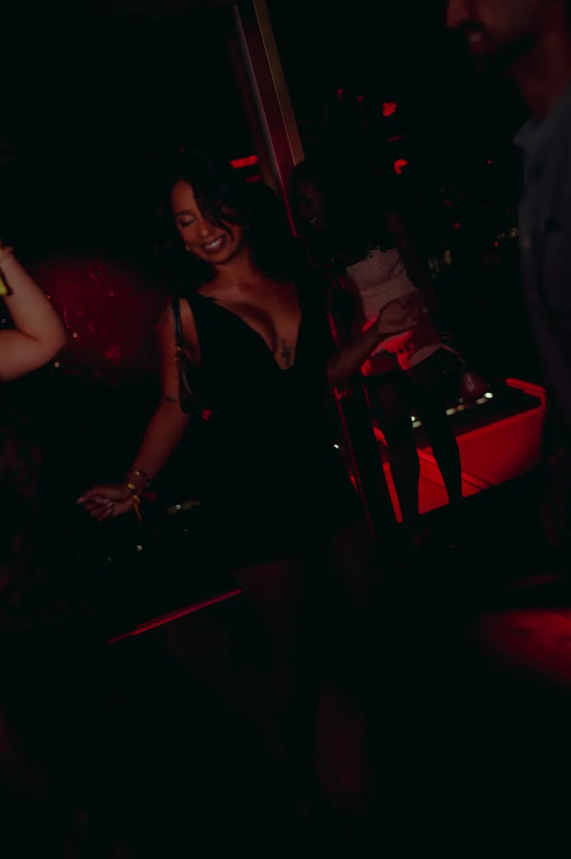 Guest dancing under red light at CE LA VI