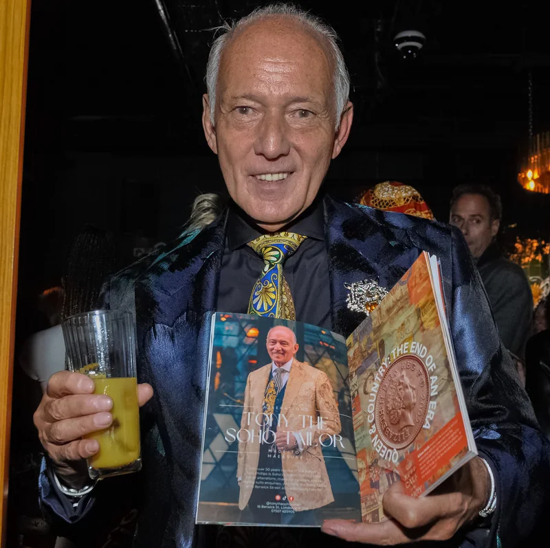 Guest holding a magazine cover portrait of himself