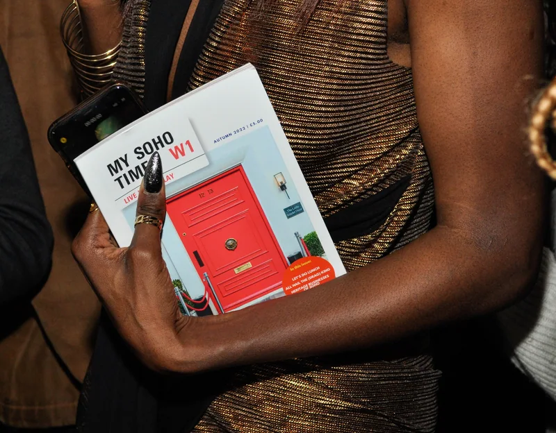 Guest holding copies of My Soho Times magazine