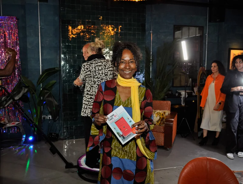 Guest holding My Soho Times magazine in a colourful jacket