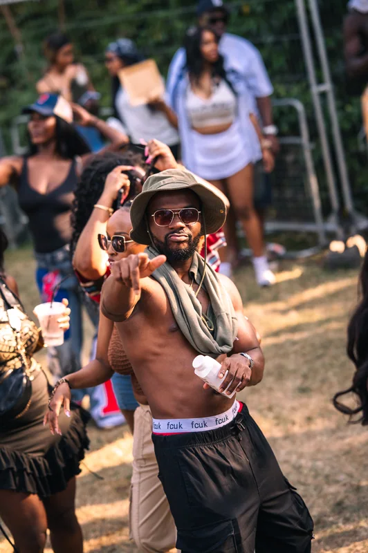 Guest in a bucket hat pointing towards the camera at Highlights