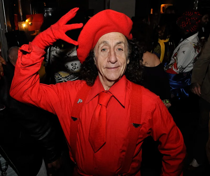 Guest in a red outfit posing at the magazine launch