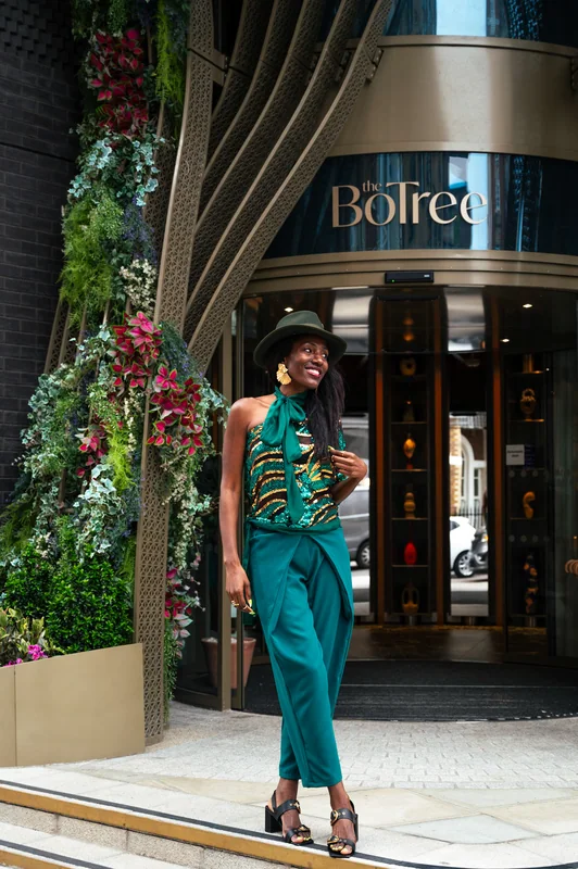 Guest in green at the entrance to The BoTree hotel