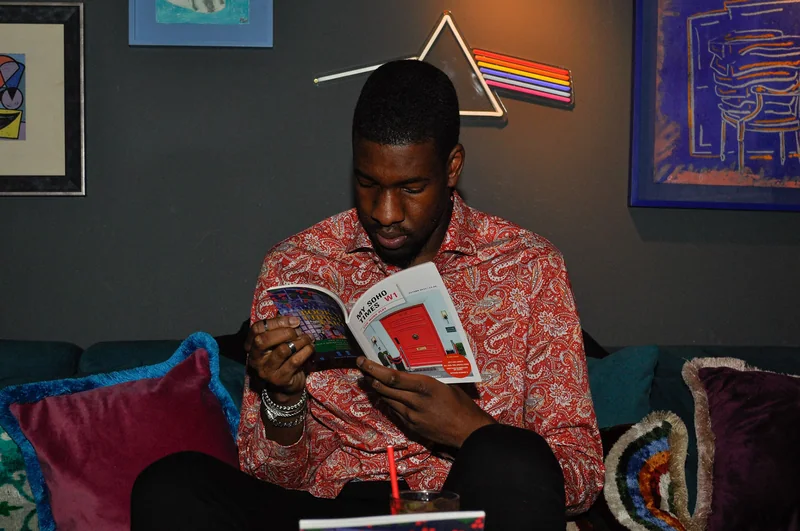 Guest reading the magazine from a lounge chair
