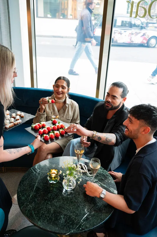 Guests and refreshments around a small lounge table