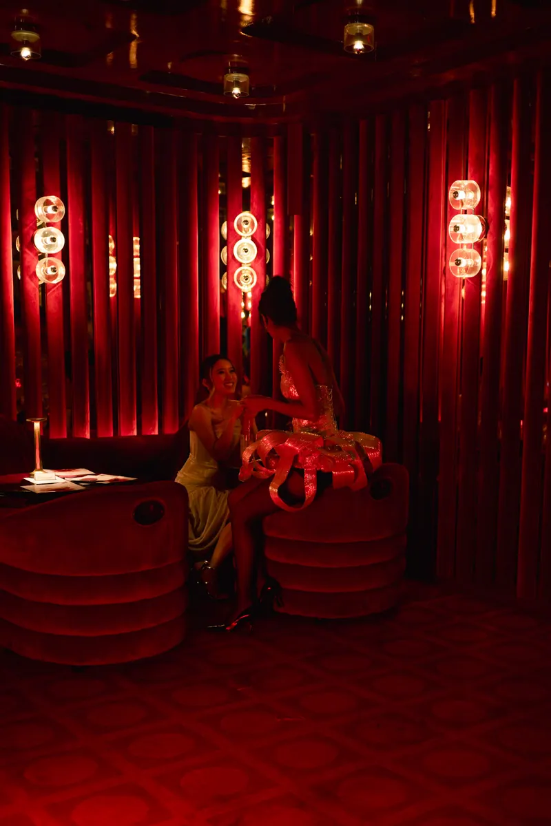 Guests talking in the red-lit FashionTV lounge