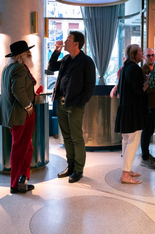 Guests gathered beneath curved hotel lighting