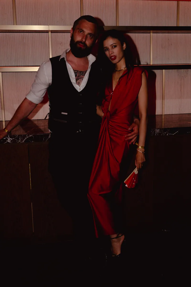 Two guests posing together in red and black at CE LA VI