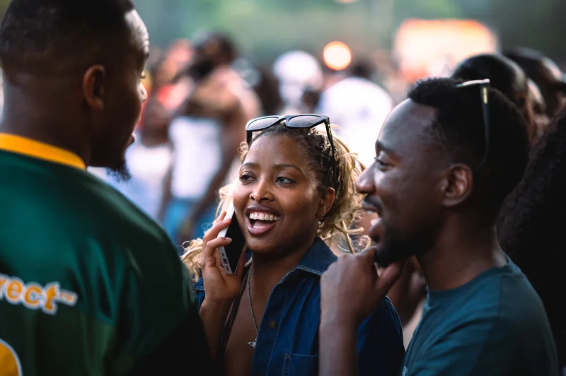 Guests smiling in conversation at the outdoor festival