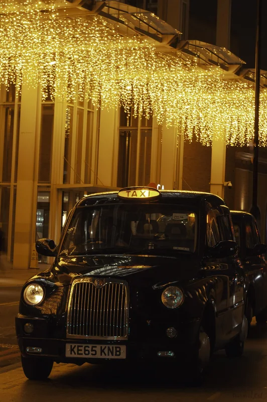 London taxi beneath a gold curtain of light