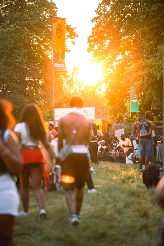 Low sun draws a path through the outdoor festival crowd.