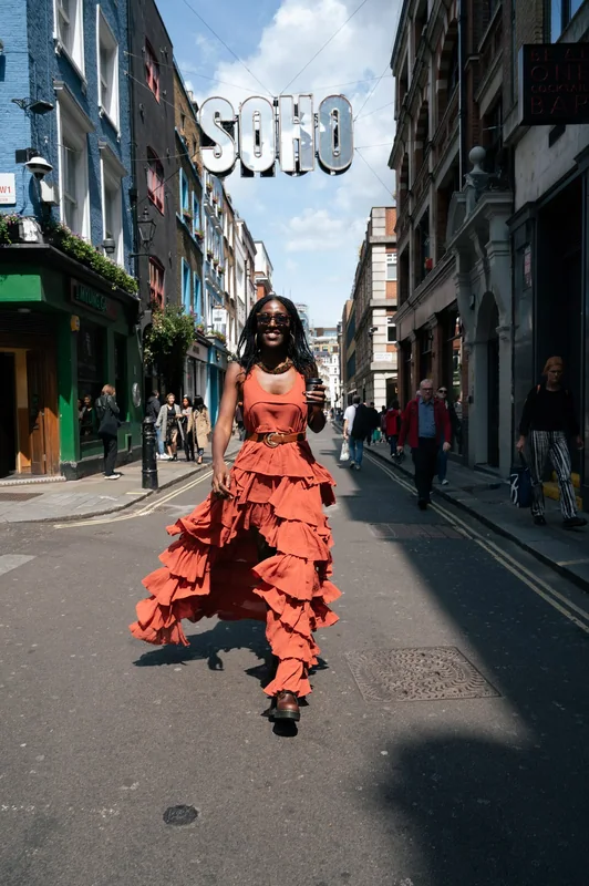 Orange dress and Soho sign create a fashion place relationship