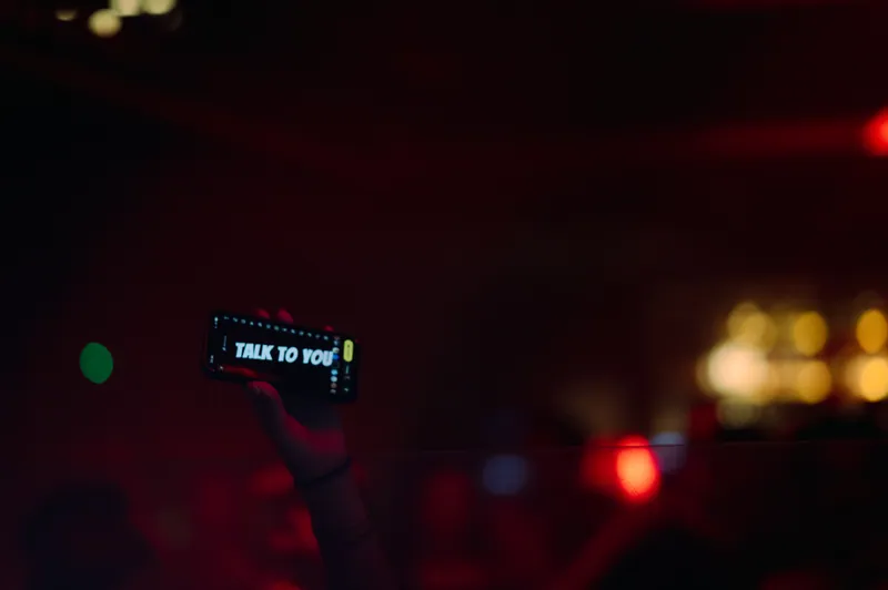Phone raised above the dance floor at 77 London