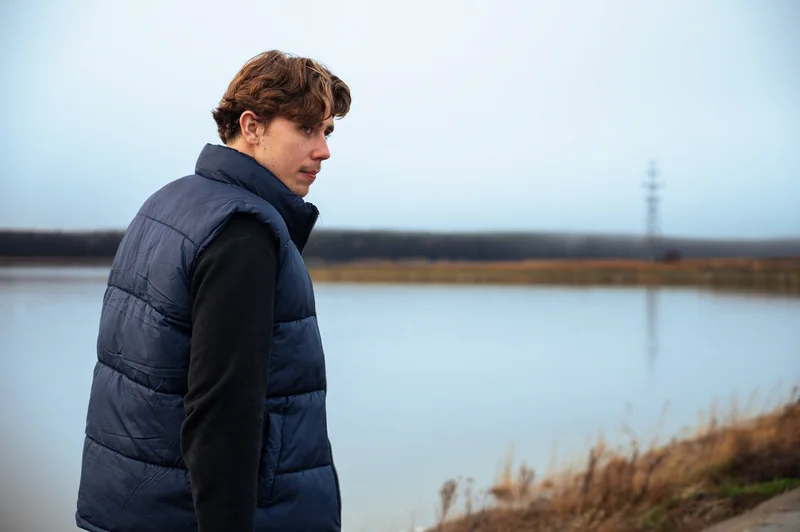 Portrait looking back beside a calm lake