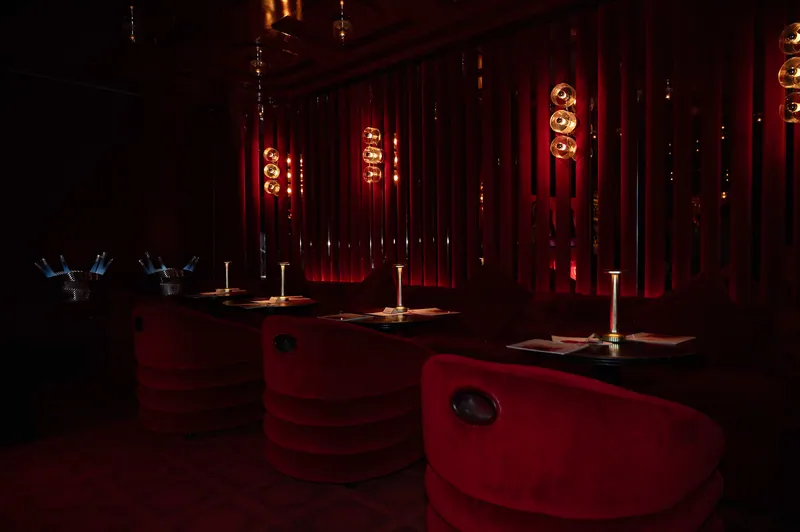 Red FashionTV lounge with velvet seating and warm table lights