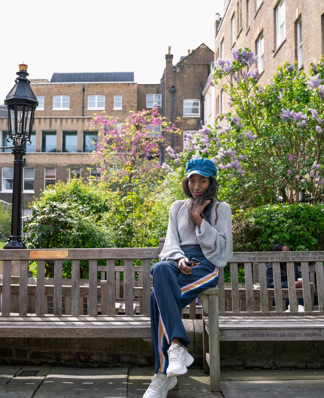 Seated fashion portrait beside flowering trees in London