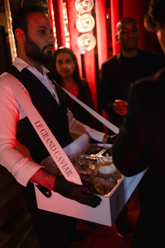 Server carrying drinks at the FashionTV event