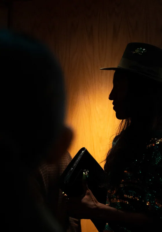 Silhouetted guest in a hat against warm light at The BoTree