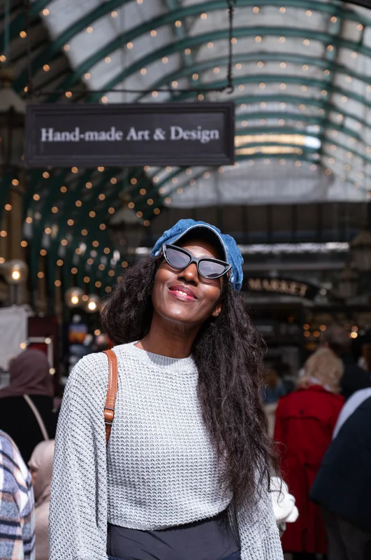 Smiling street portrait beneath a covered market roof