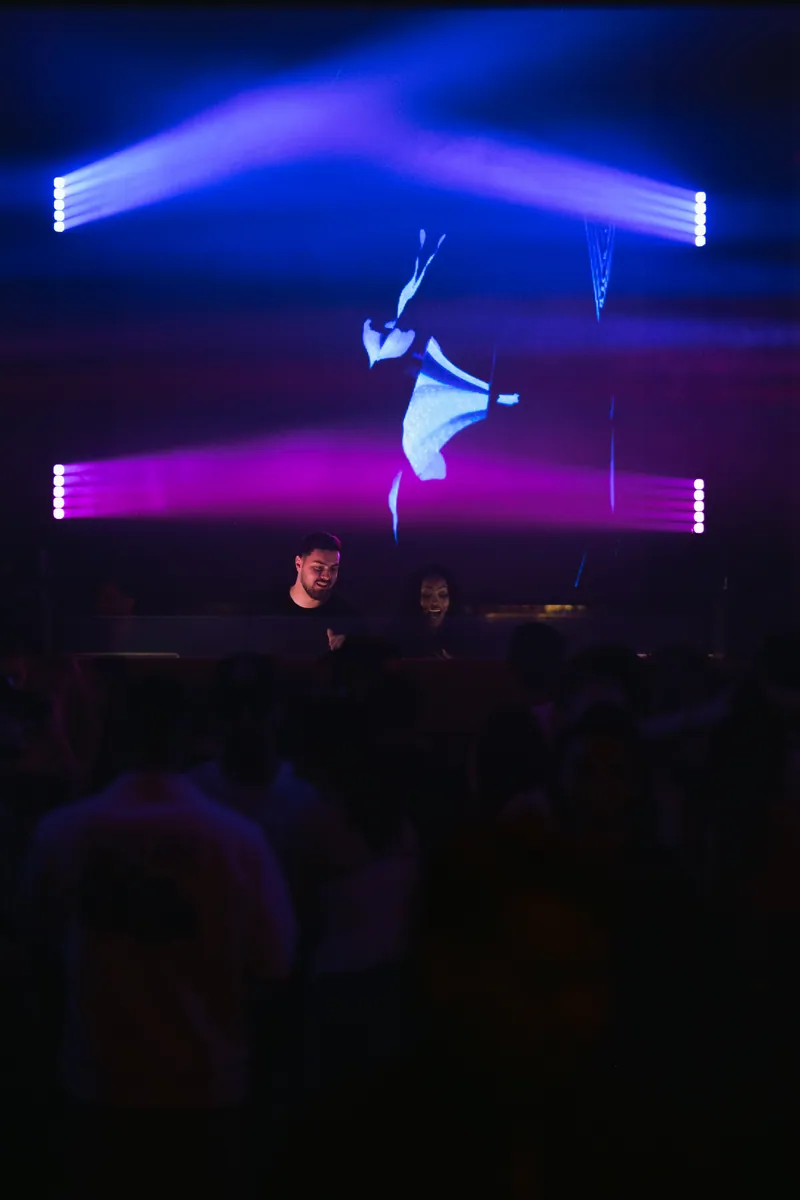 Stage and dance floor under violet light at 77 London