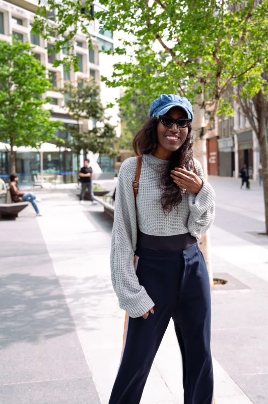 Street portrait in a blue cap and wide-leg jeans