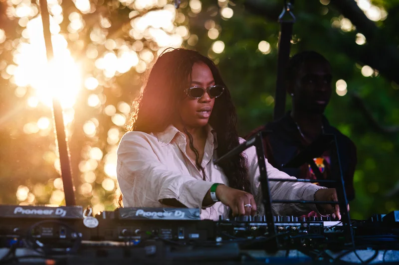 Sunlight behind the DJ at the outdoor mixing desk