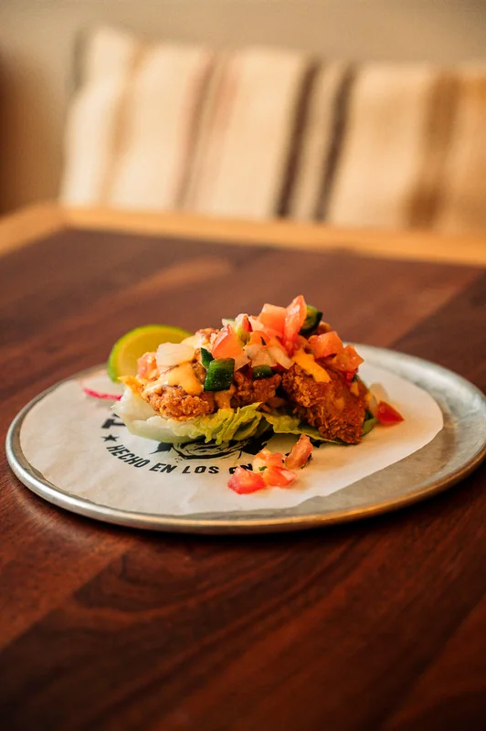 Topped taco in warm light on a wooden table