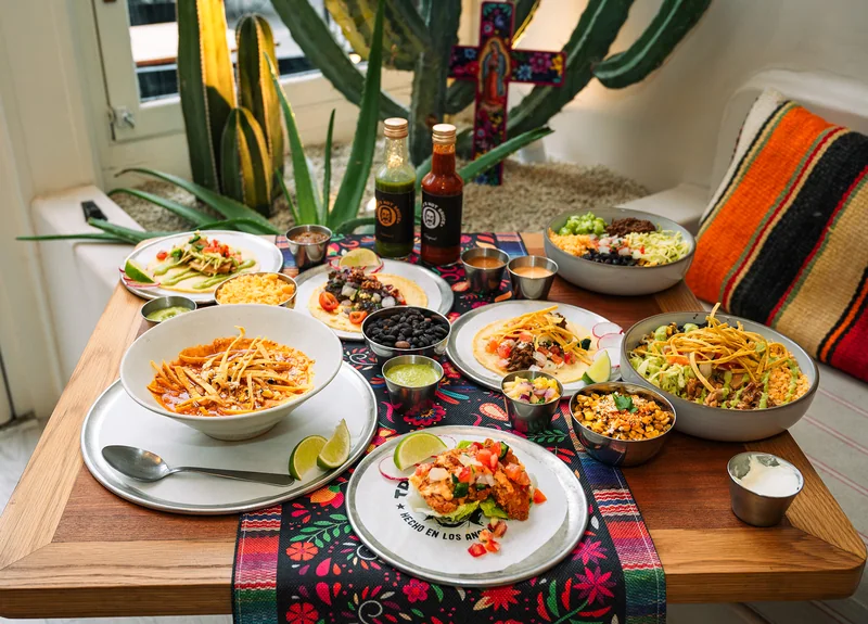 Trejo’s Tacos table spread beside a window and cactus