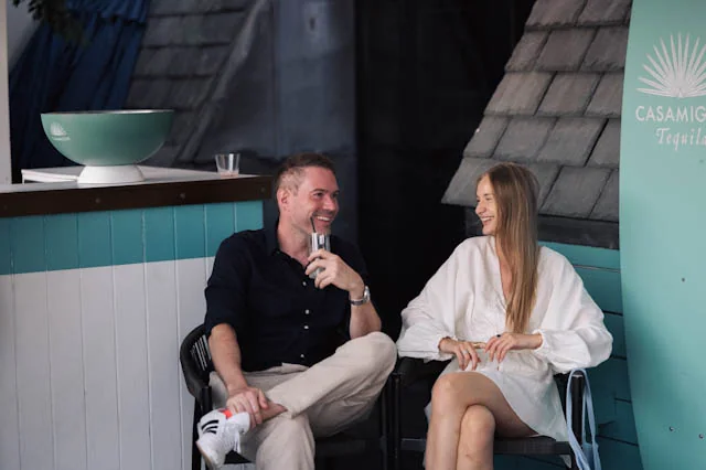 Two guests sharing a laugh on the Aqua Nueva terrace