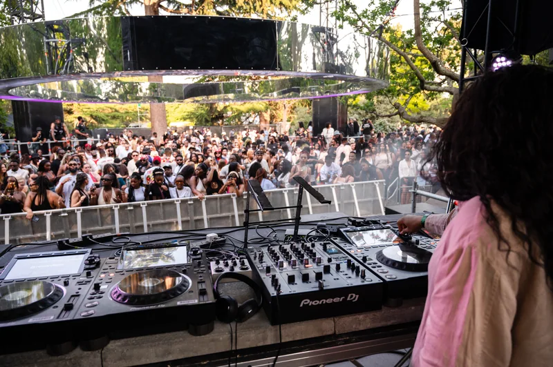 View from behind the DJ across the festival crowd