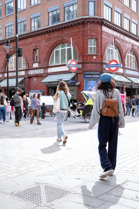 Walking portrait beside a London Underground entrance